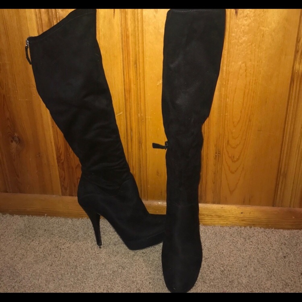 Knee high black suede platform boots.